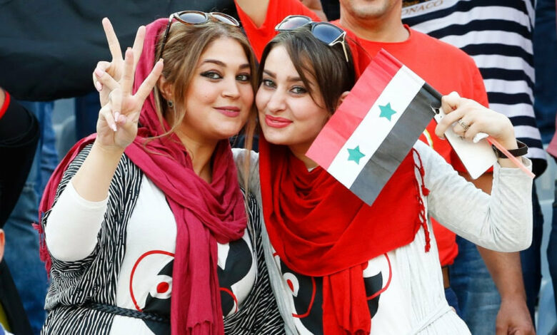 Two Syrian fans in the Azadi Stadium in Tehran, Iran during an Iran-Syria game. Via The Guadian. Photograph: Abedin Taherkenzareh/ EPA