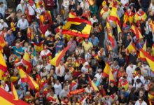 People wave Spanish national flags as thousands packed the central Cibeles square to in Madrid, Spain, Saturday, Sept. 30, 2017. Picture via Voice of America