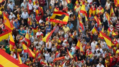 People wave Spanish national flags as thousands packed the central Cibeles square to in Madrid, Spain, Saturday, Sept. 30, 2017. Picture via Voice of America