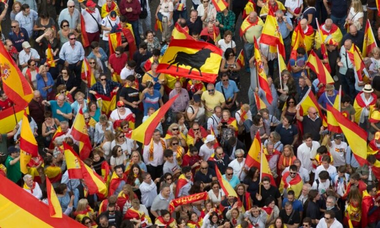 People wave Spanish national flags as thousands packed the central Cibeles square to in Madrid, Spain, Saturday, Sept. 30, 2017. Picture via Voice of America