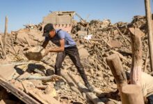 Young man searching in the rubble of a devastated neighbourhood in Marrakech via Middle East Monitor Arabic