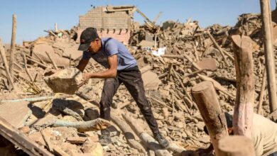 Young man searching in the rubble of a devastated neighbourhood in Marrakech via Middle East Monitor Arabic