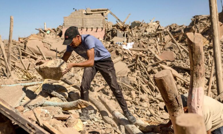 Young man searching in the rubble of a devastated neighbourhood in Marrakech via Middle East Monitor Arabic